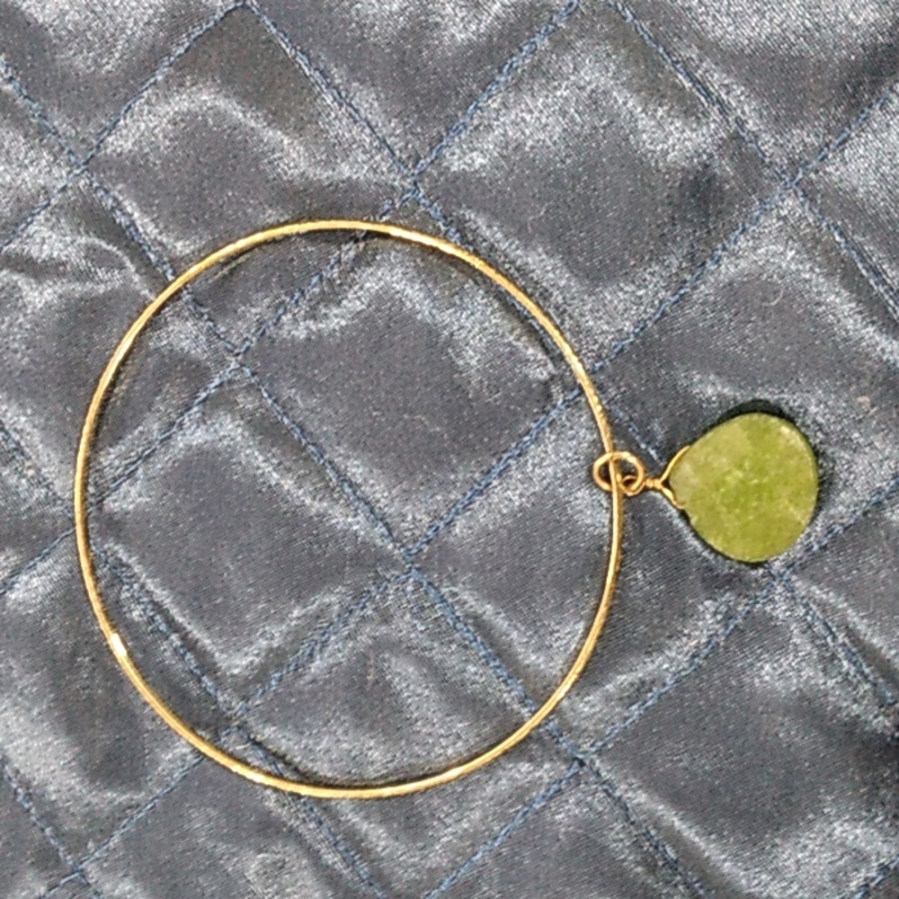 Bracelet  are golden with green stones